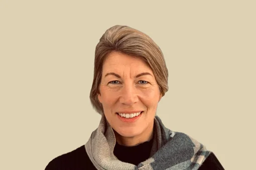 Judy Neudorf, Case Manager Professional headshot of Judy Neudorf, a case manager, wearing a scarf and smiling against a brown background.