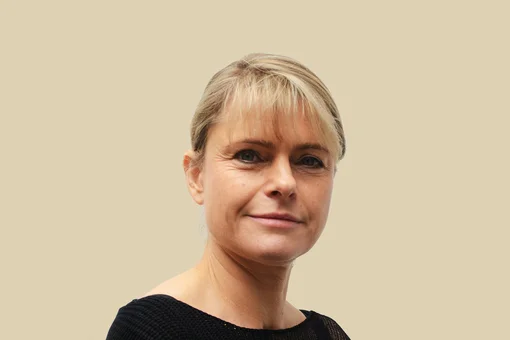 Pia Ritter, Office Manager Professional headshot of Pia Ritter, an office manager, smiling against a brown background.